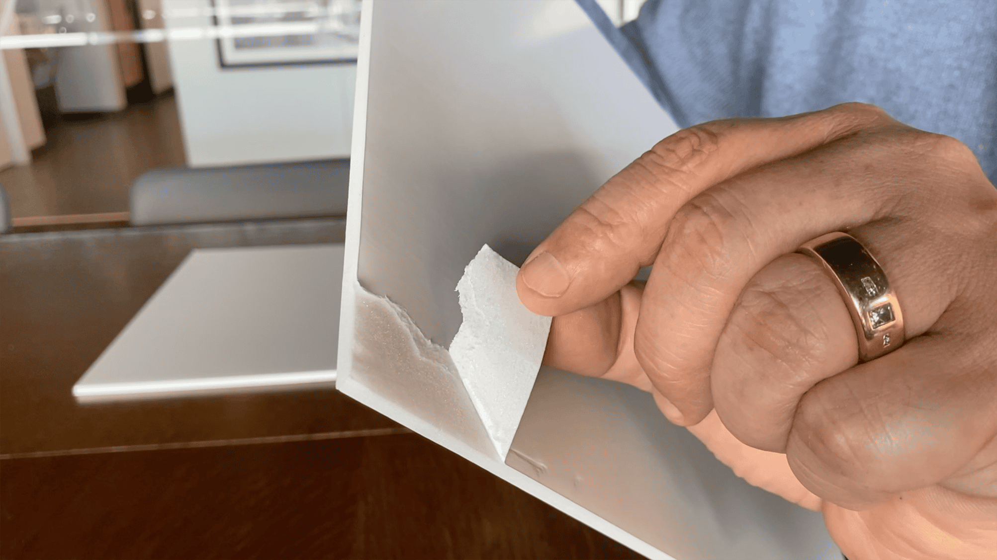Paper Based Foam Board Sample Being Peeled Back To Reveal Inside Material